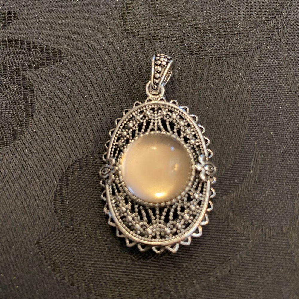 Sterling Silver Intricate Design Pendant With Light Cream Color Center Stone